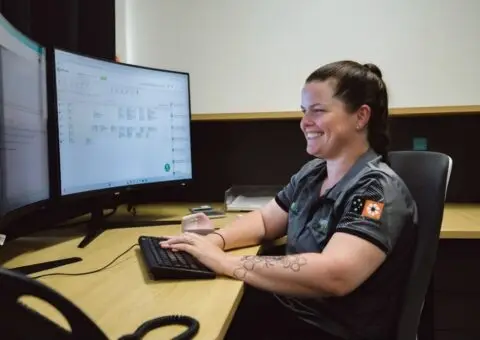 Woman working at dual monitors in office