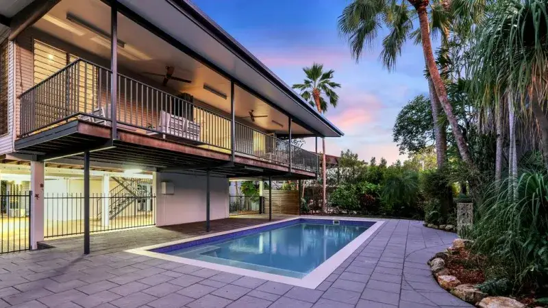 Modern two-storey home with pool and palms